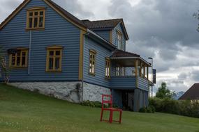 red chair near the wooden house