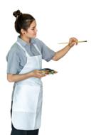 a girl in an apron in a shirt draws
