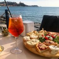 delicious snacks with a cold drink overlooking the sea