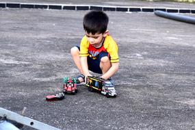 Child playing with toys on street