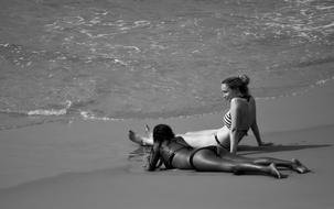 black and white, two girls on the sand on the beach