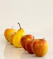 Sweet apples and pears on a white background