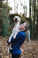 girl holding a big dog