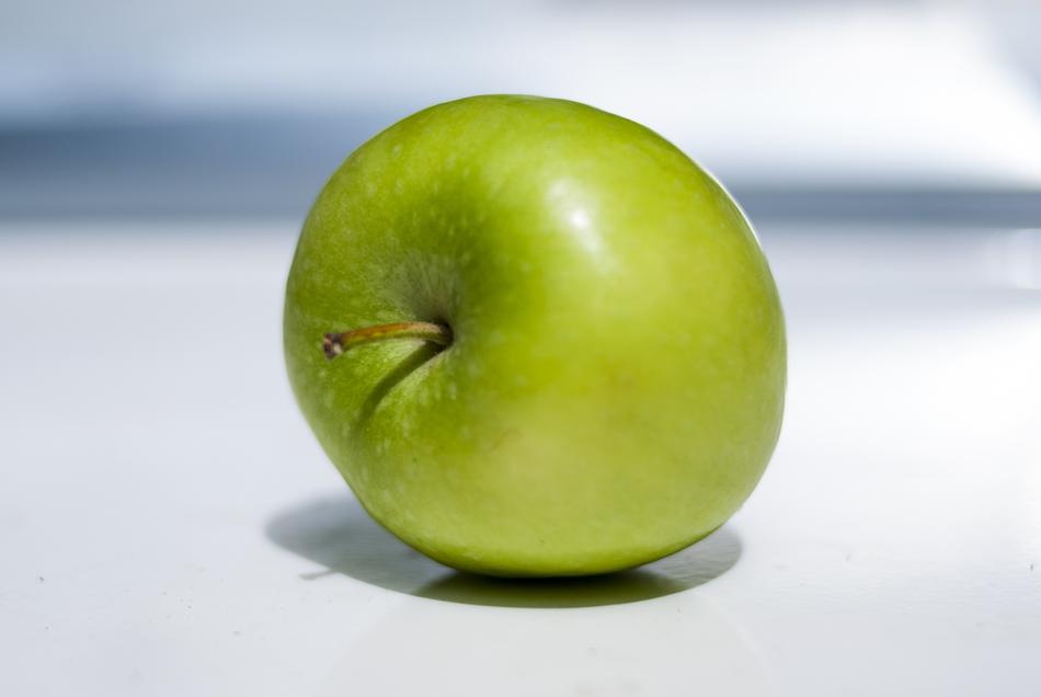 ripe green apple on a white background
