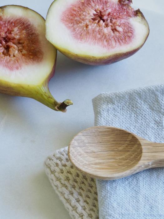 ripe tropical fruits and a wooden spoon