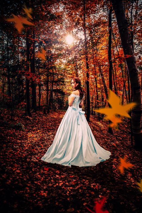 a girl in a white dress in the autumn forest