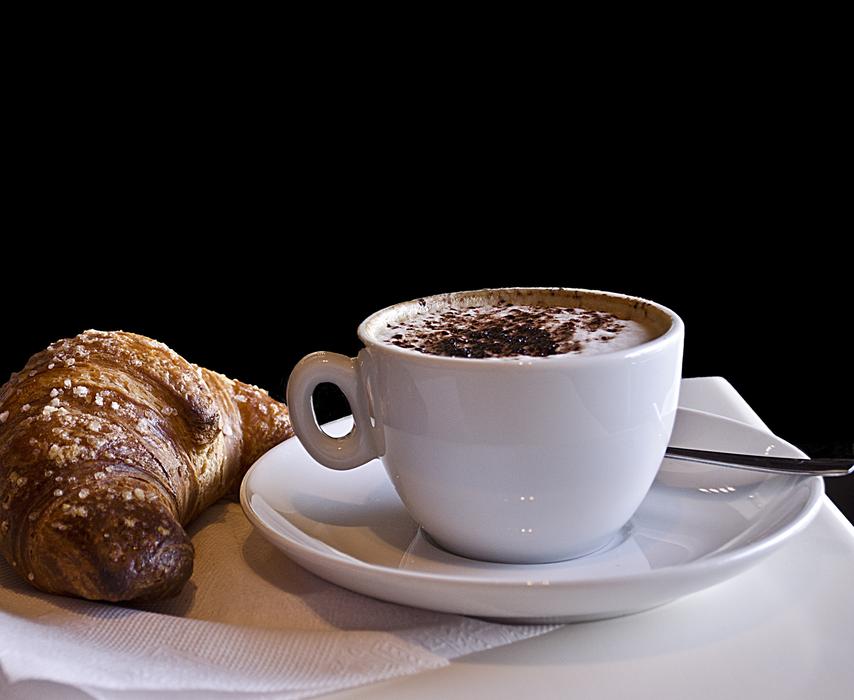 Sesame croissant with a hot drink