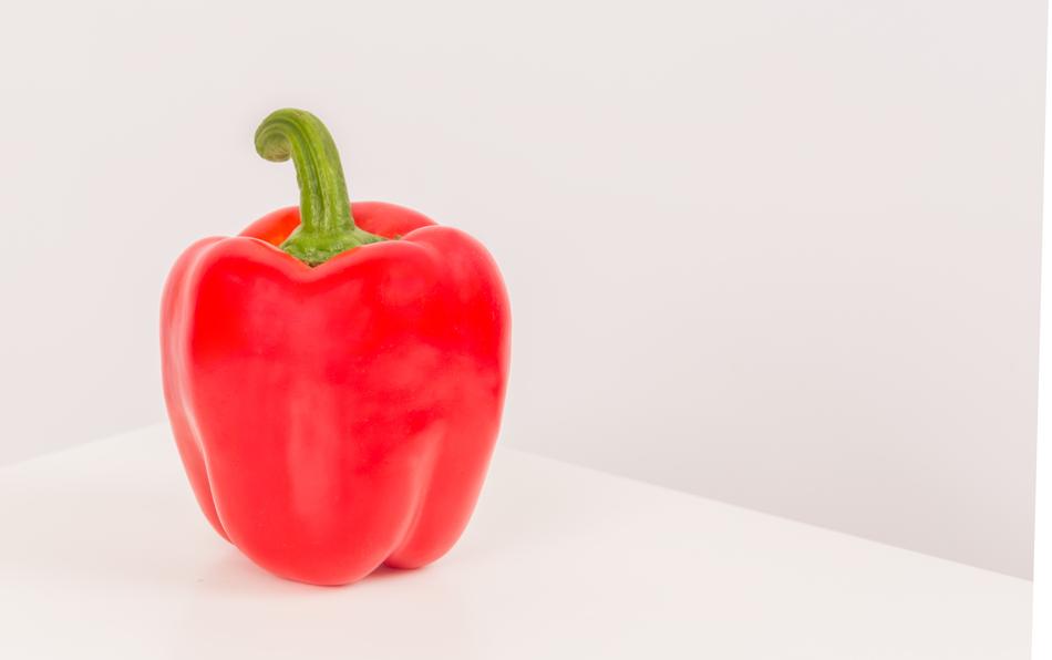 Red juicy peppers on a white background