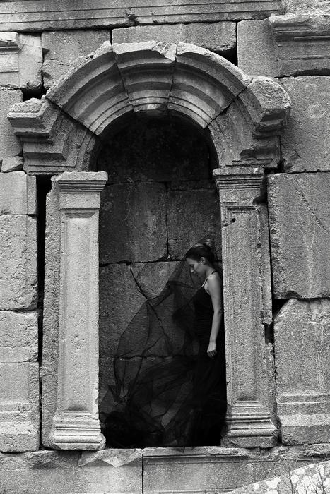 the girl in the black dress near the ruins