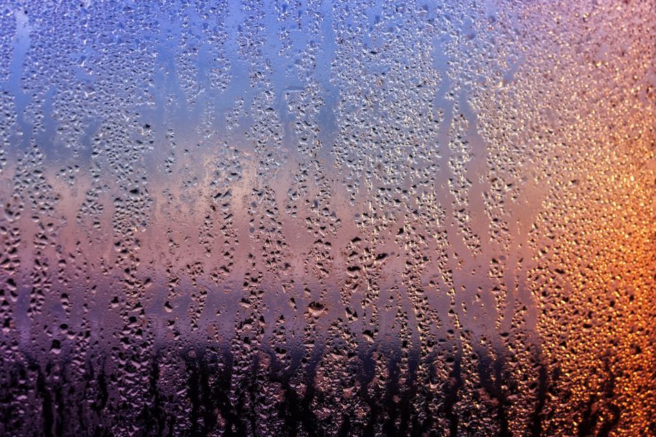 wet window at colorful sunset
