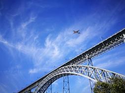 airplane in front of the bridge