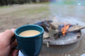 coffee mug with the fire as a backdrop