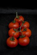 delicious tomatoes on a black background