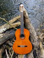acoustic Guitar on wood above water
