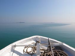 white boat with a rope on the lake