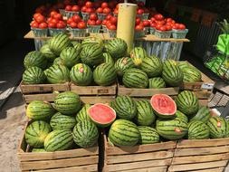 Sweet juicy watermelons at the market in wooden boxes