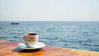 hot coffee against the sea