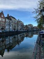 buildings and parked cars on the bank of a canal in Amsterdam, Holland