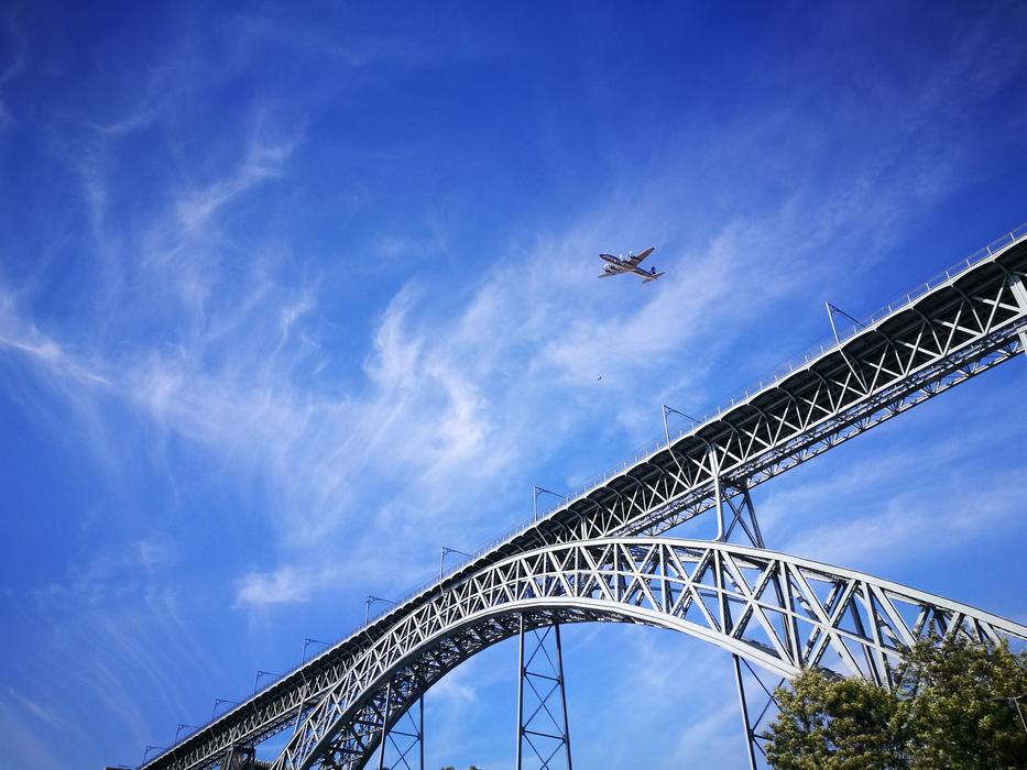 airplane in front of the bridge