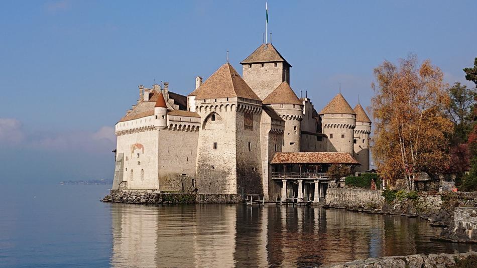 castle by the lake with autumn trees