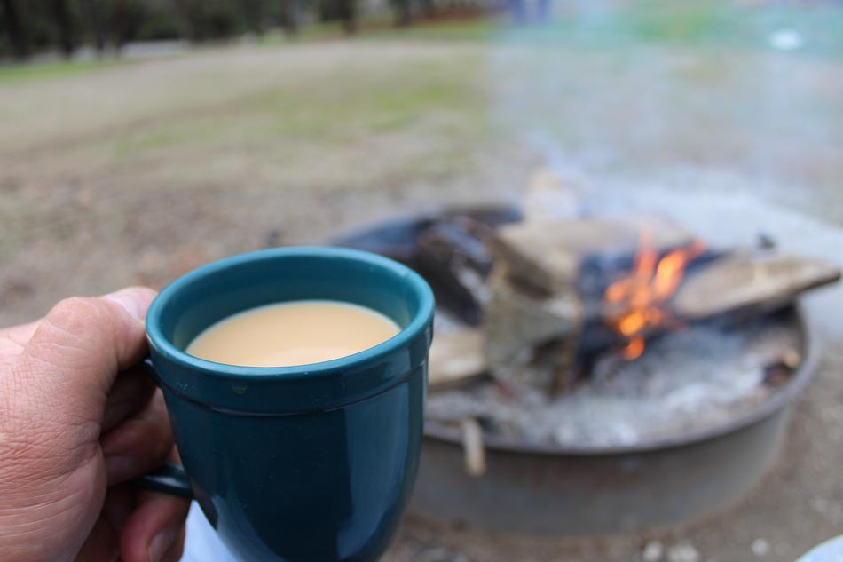 coffee mug with the fire as a backdrop
