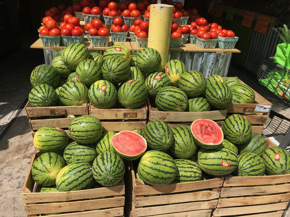 Sweet juicy watermelons at the market in wooden boxes