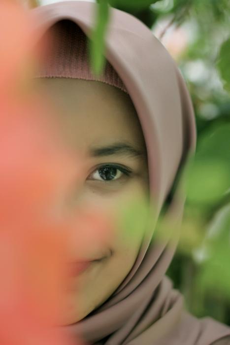 a girl peeking around the corner