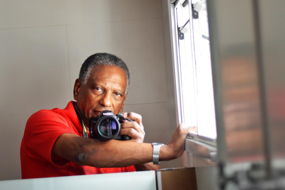 guy in a red t-shirt with a camera