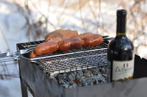 bottle of grilled beer with fried sausages
