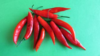 Freshly grilled hot peppers on a green grill