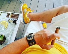 man sitting with a cigar in his hand