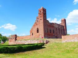 a red castle in the green grass