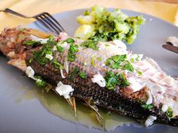 Fried fish with onions and basil