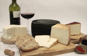 Cheese snacks and bread on a wooden board