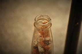Cigarette butts in a glass bottle