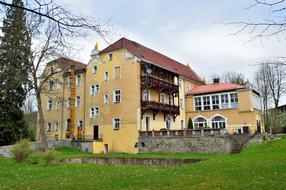 yellow house with green grass