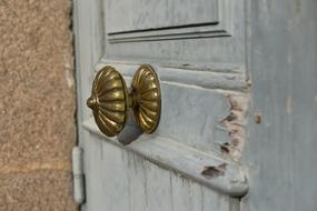 the gold handle on the white door