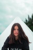 girl with long hair on the background of a white tent