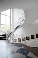 white staircase against a backdrop of paintings