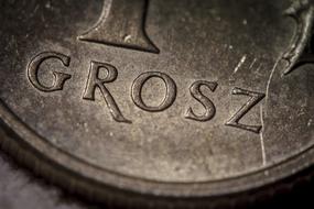 Close-up of the old coin with sign, with stains