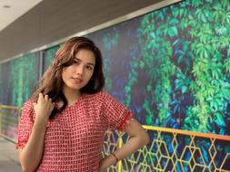 Cute Girl model posing by the wall