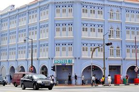 blue house with cars and people