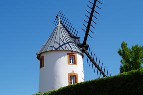 white windmill on a blue background