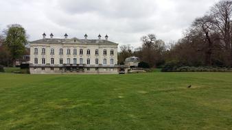 the building is white in a green field