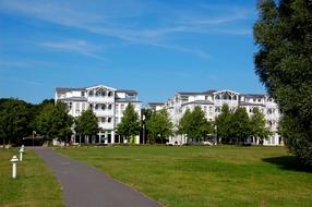 green lawn near white buildings