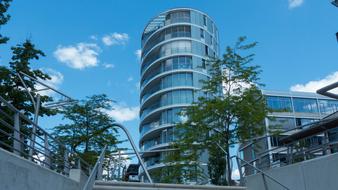 high glass tower with trees