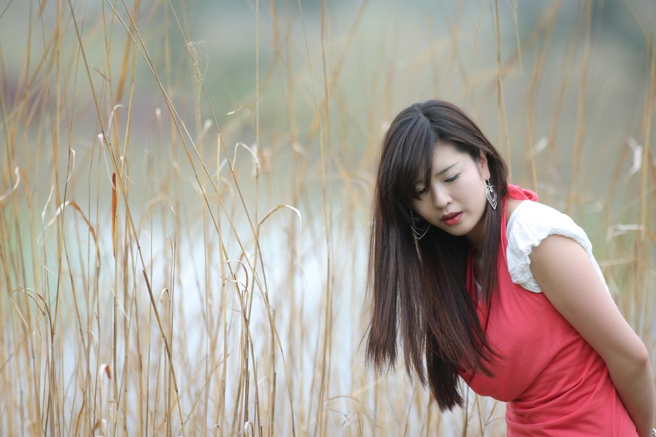 korean girl in a red dress on a reed background