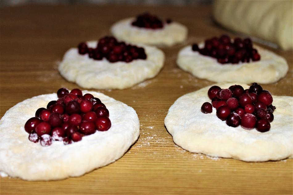 Juicy berries on raw dough