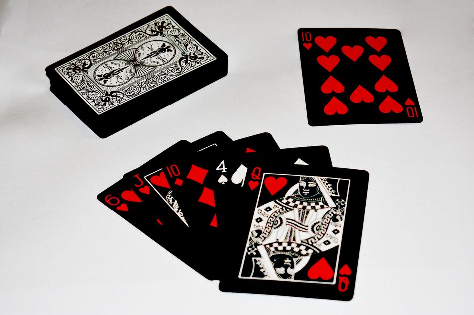 Black, white and red deck of cards, on the white surface