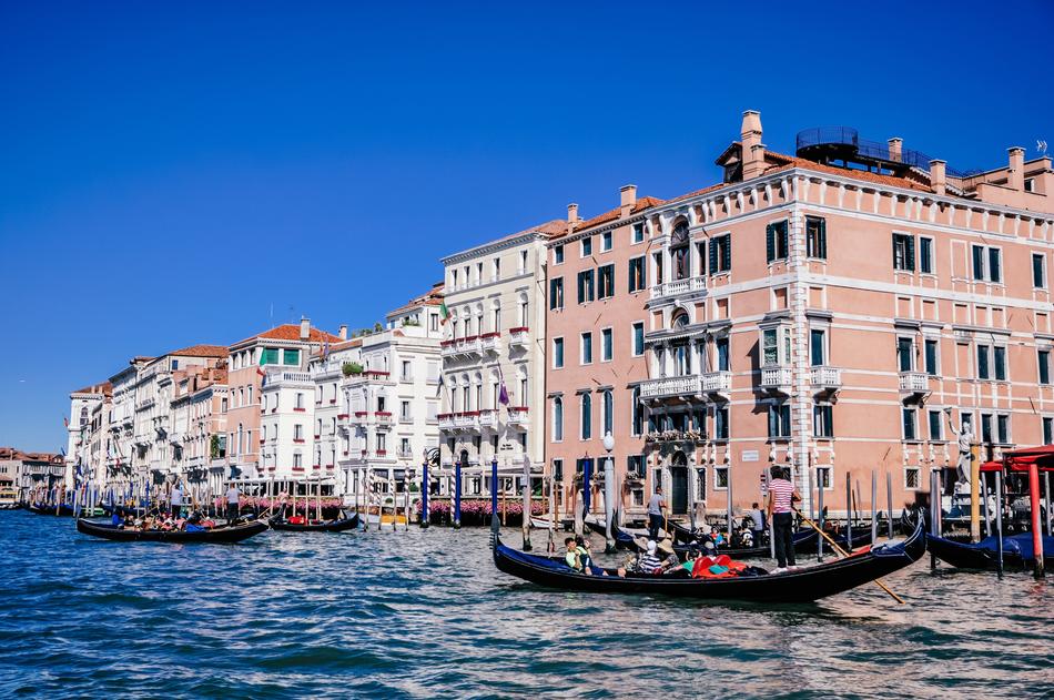 a big building with a boat in the river